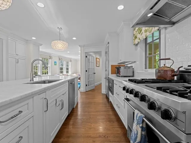 a large kitchen with stainless steel appliances granite countertop a stove and a sink