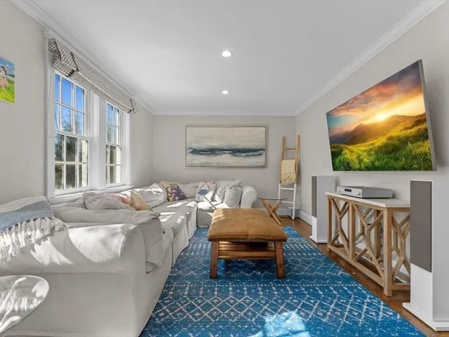 a bed room with furniture and a flat screen tv