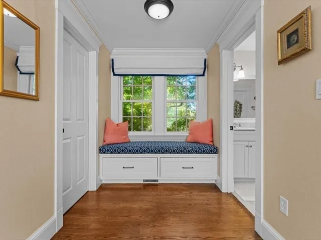 a room with a window and a dresser