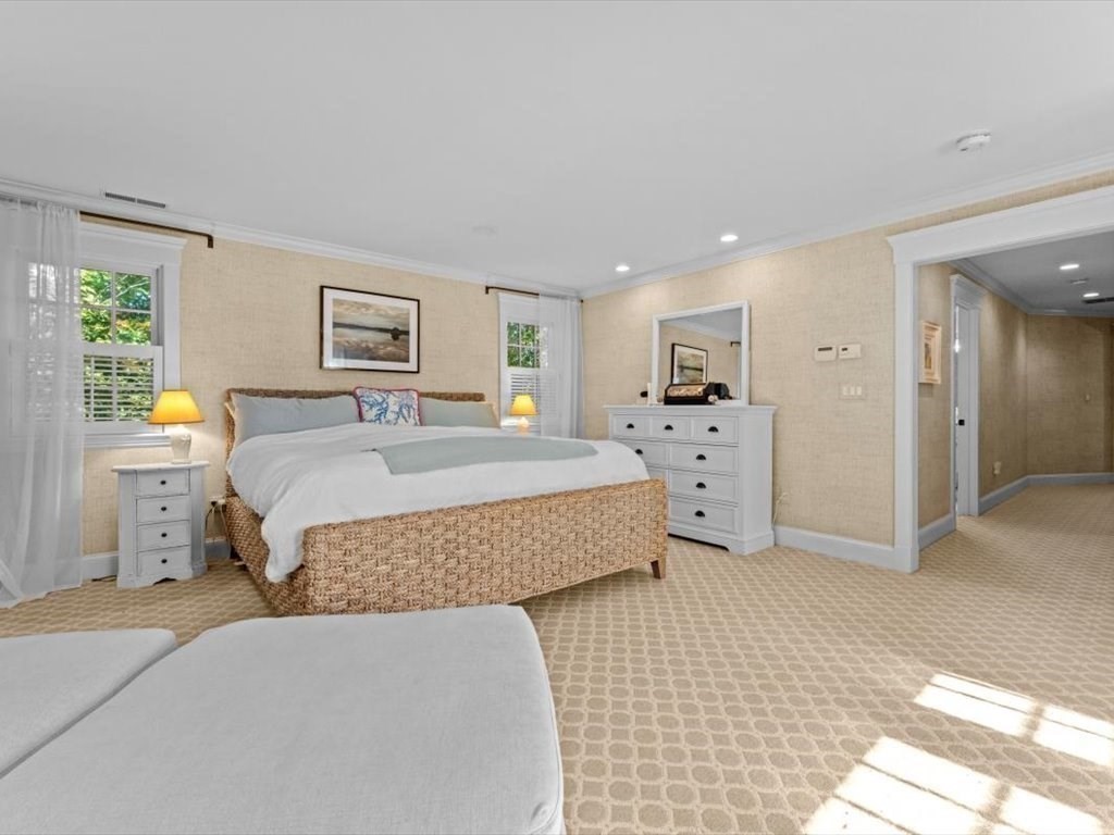 25 Forest Street Manchester, MA 01944 - Photo 20 of 34 a spacious bedroom with a bed and a couch