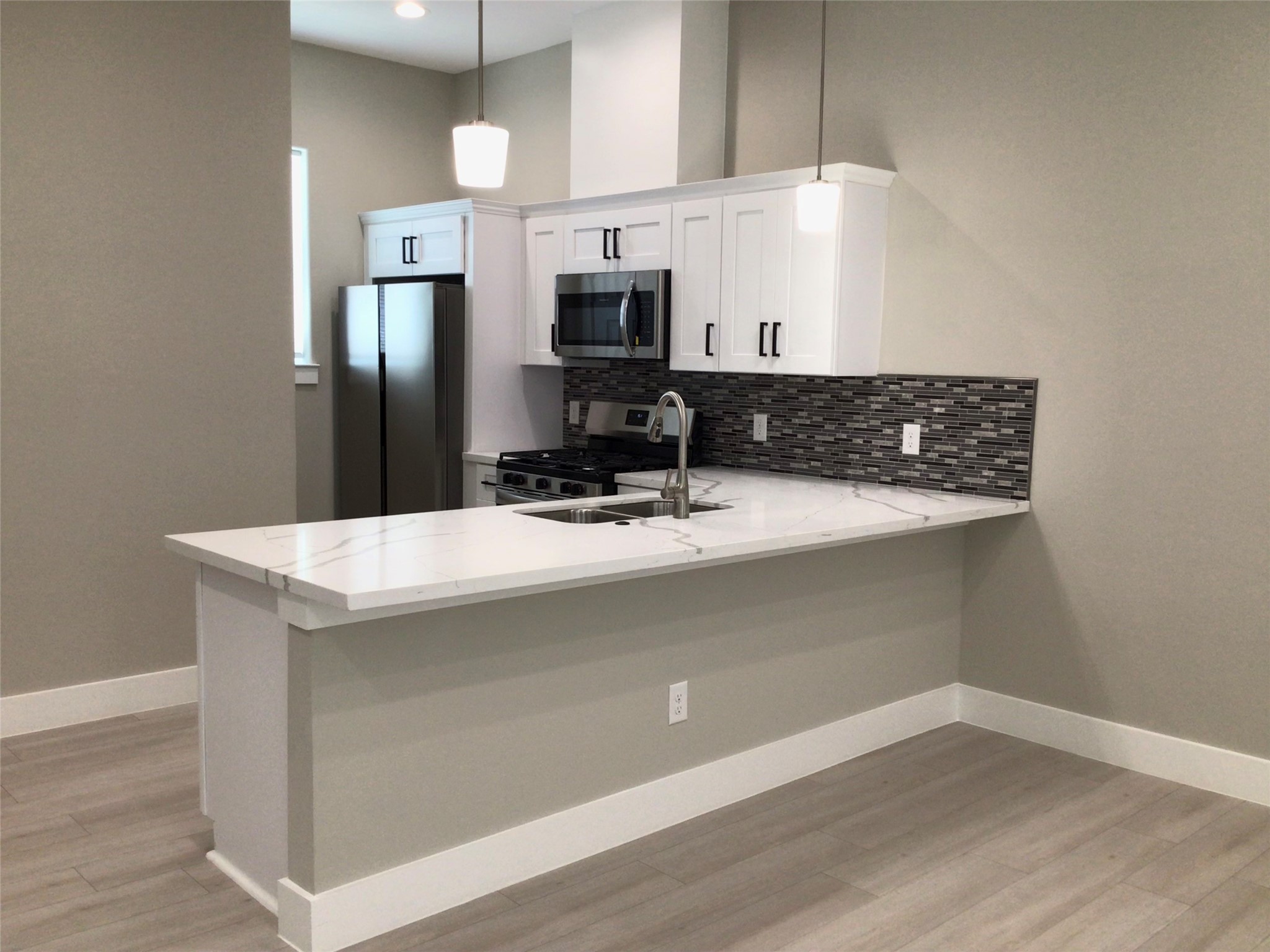 2109 Marnel Road, Unit B Houston, TX 77055 - Photo 12 of 46 a kitchen with a refrigerator and a sink