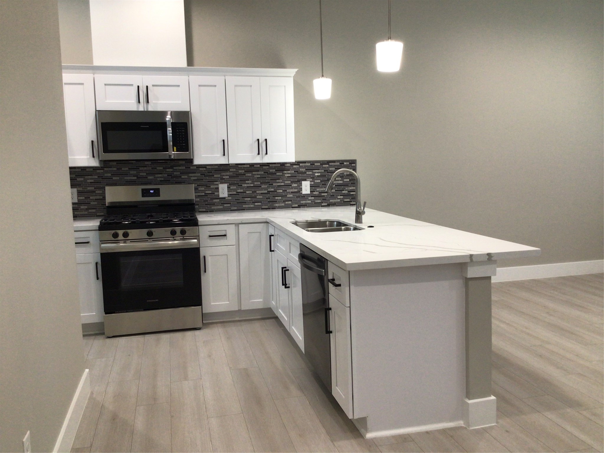 2109 Marnel Road, Unit B Houston, TX 77055 - Photo 13 of 46 a kitchen with a stove and a microwave