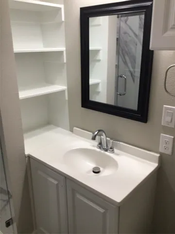 a view of a patio with table and chairs potted plants and large tree