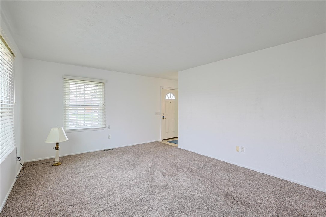 4307 Meadowcroft Road Dayton, OH 45429 - Photo 8 of 26 This bright living area features soft carpet and ample natural light through a large window.