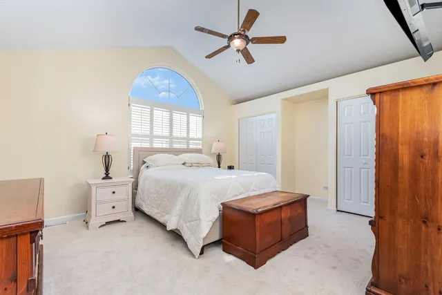 a spacious bedroom with a bed and a window