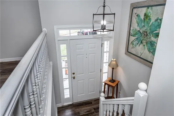 a view of hallway with wooden floor and stairs