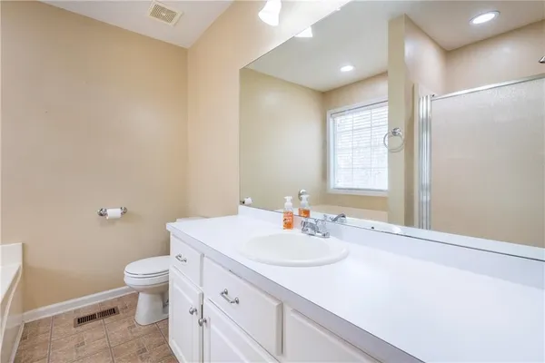a bathroom with a sink toilet and a mirror