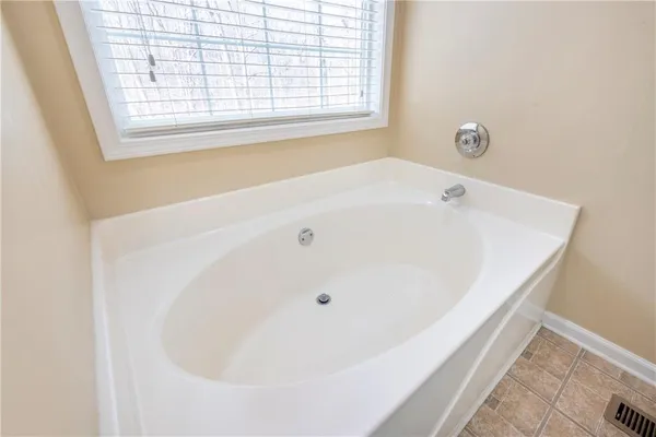 a bath tub sitting in a bathroom next to a window