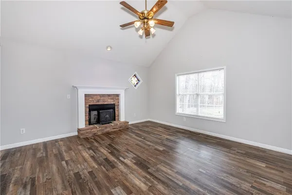 wooden floor chandelier fan and windows in a room