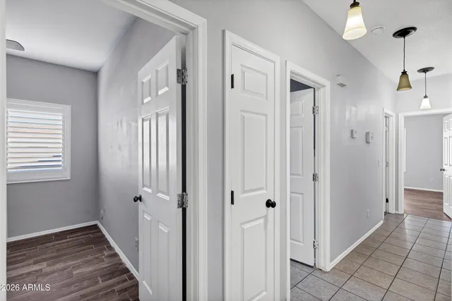 a view of a hallway with wooden floor and staircase