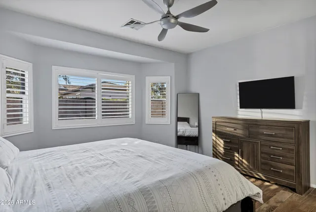 a bedroom with a bed and a flat screen tv