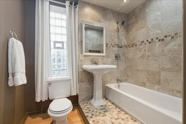a bathroom with a sink toilet and bathtub