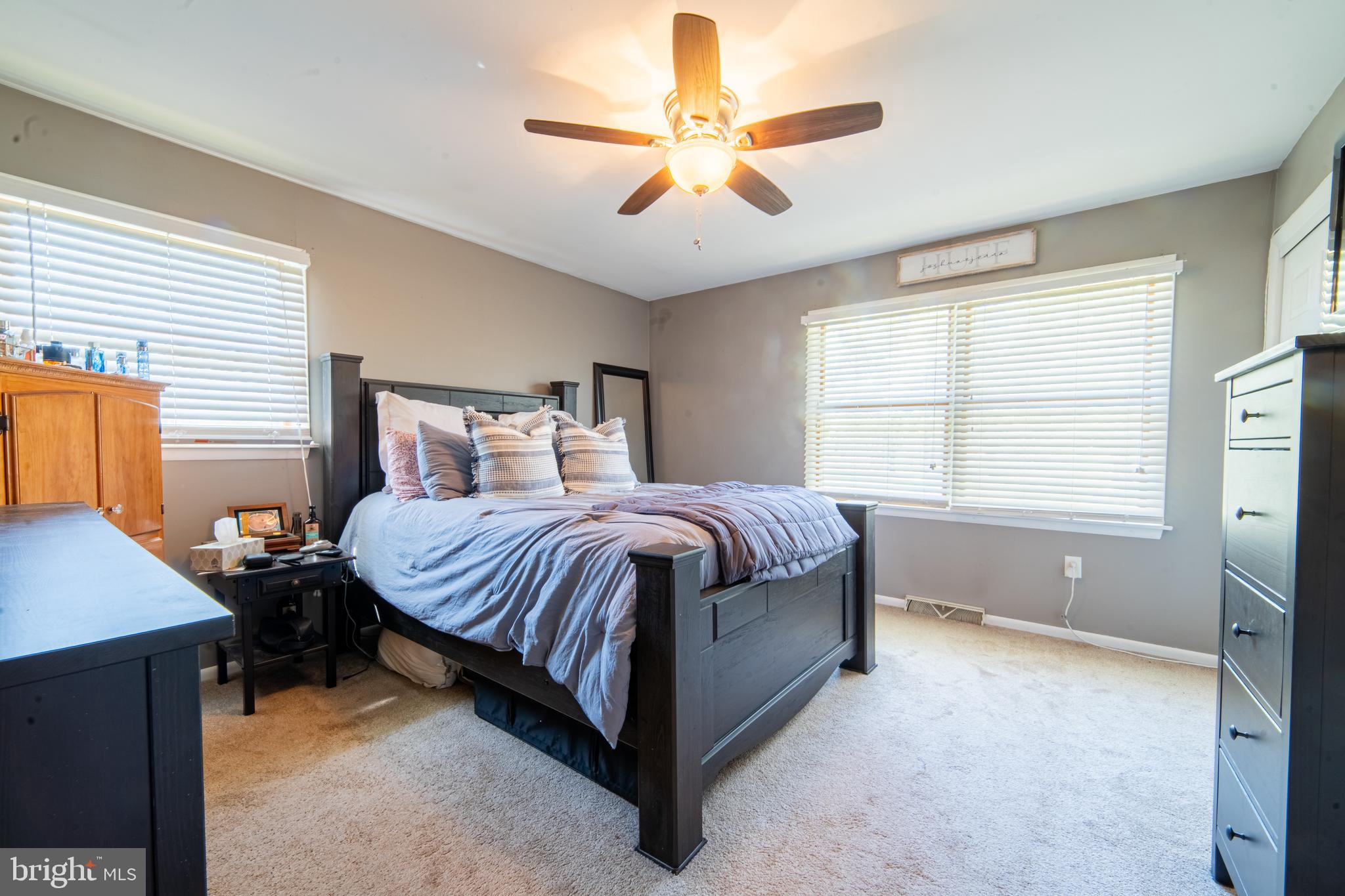49 Husted Station Road Bridgeton, NJ 08302 - Photo 24 of 33 a spacious bedroom with a bed and a chandelier