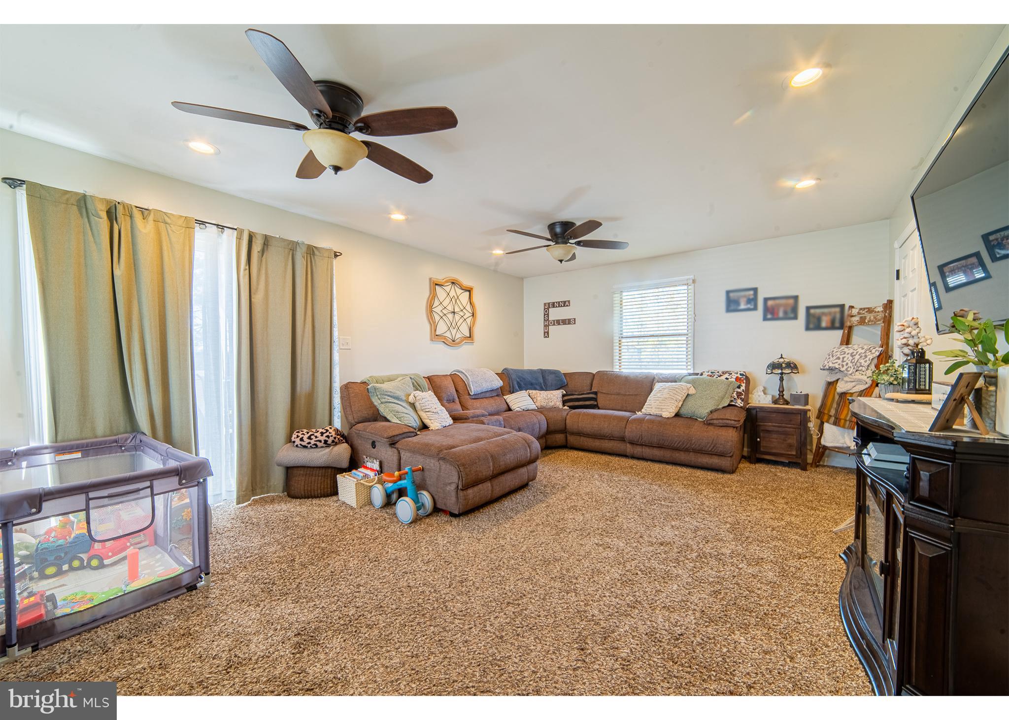 49 Husted Station Road Bridgeton, NJ 08302 - Photo 32 of 33 a living room with furniture ceiling fan and a rug