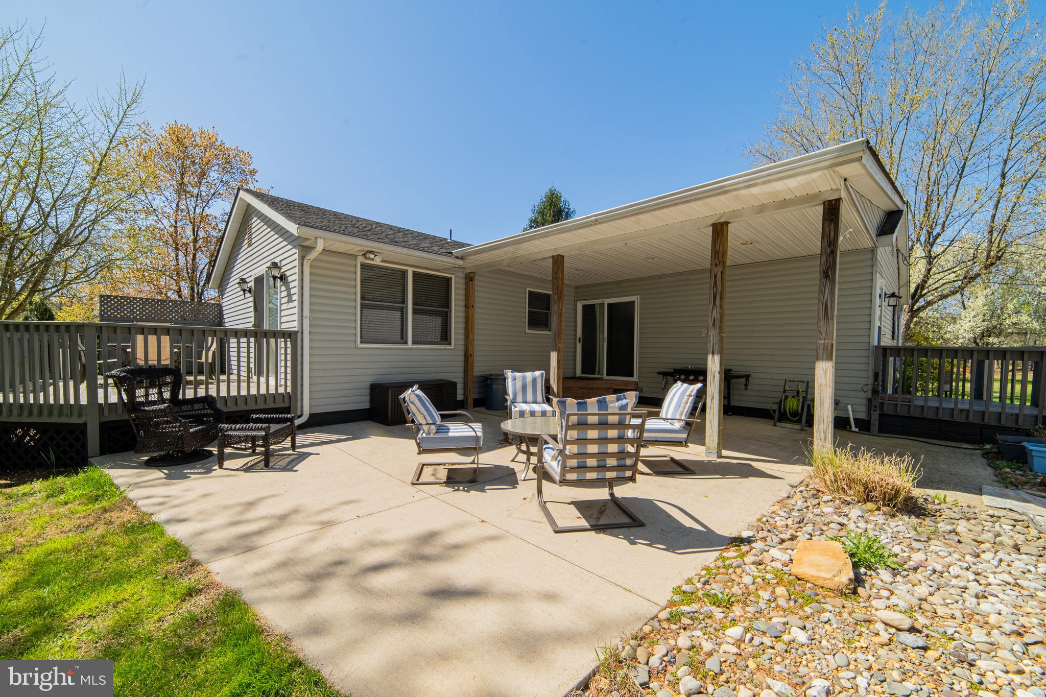 49 Husted Station Road Bridgeton, NJ 08302 - Photo 7 of 33 a view of a patio with a table and chairs and wooden fence