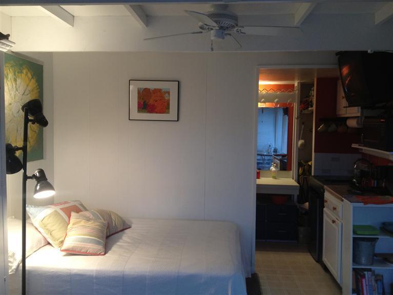 169 Shore Road, Unit 19 Truro, MA 02666 - Photo 3 of 15 a bedroom with a bed and a flat tv screen on wall