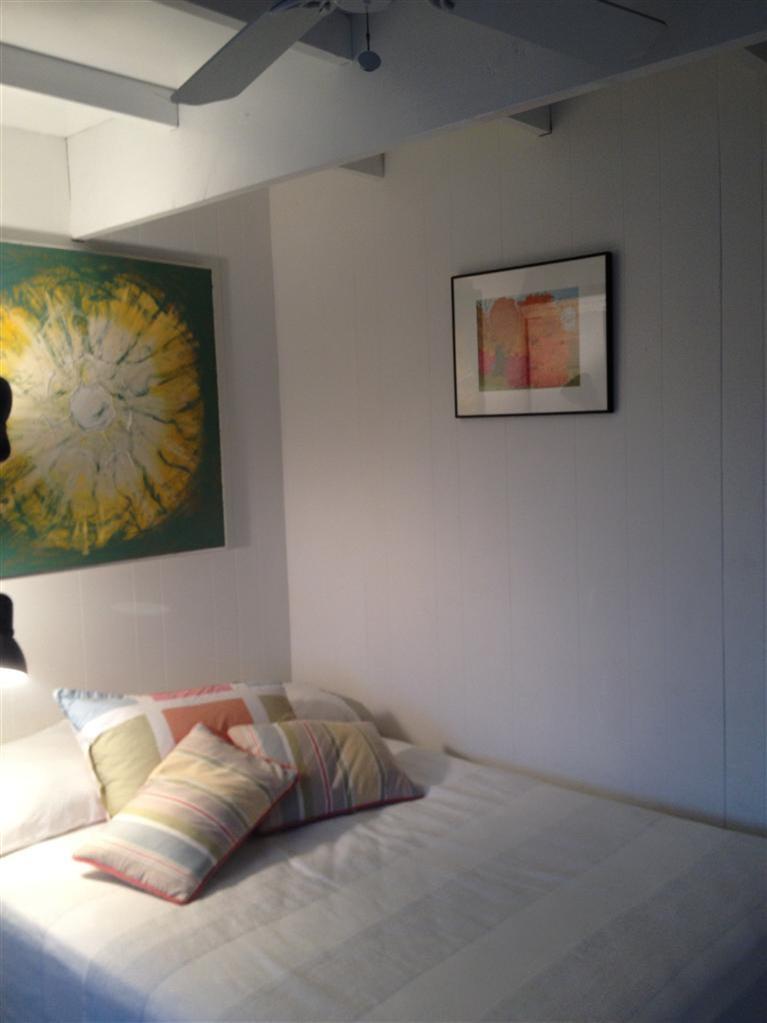 169 Shore Road, Unit 19 Truro, MA 02666 - Photo 4 of 15 a bed sitting in a bedroom next to a wall