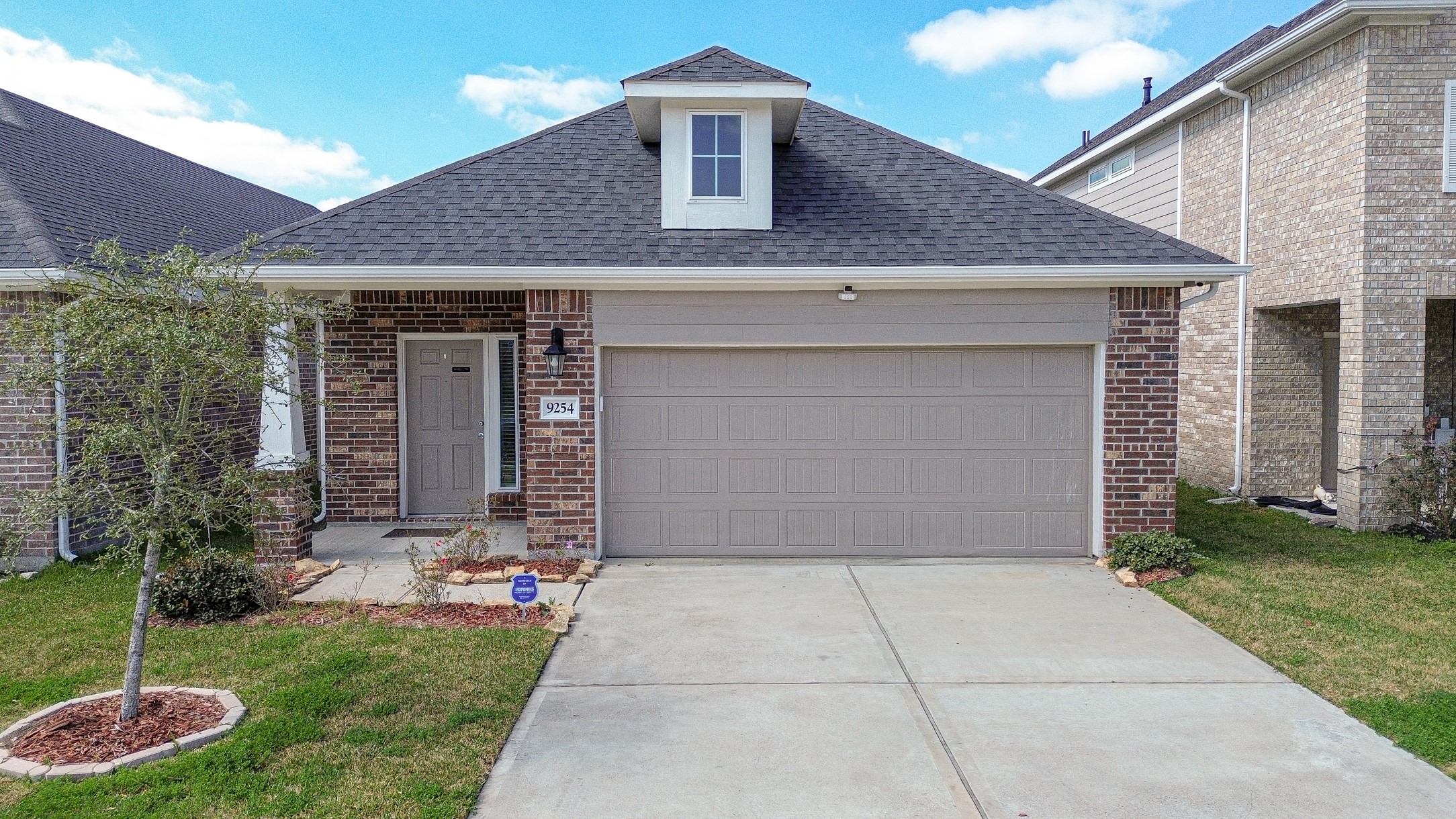 9254 Sea Gdn Street Houston, TX 77034 - Photo 1 of 33 a front view of a house with garden
