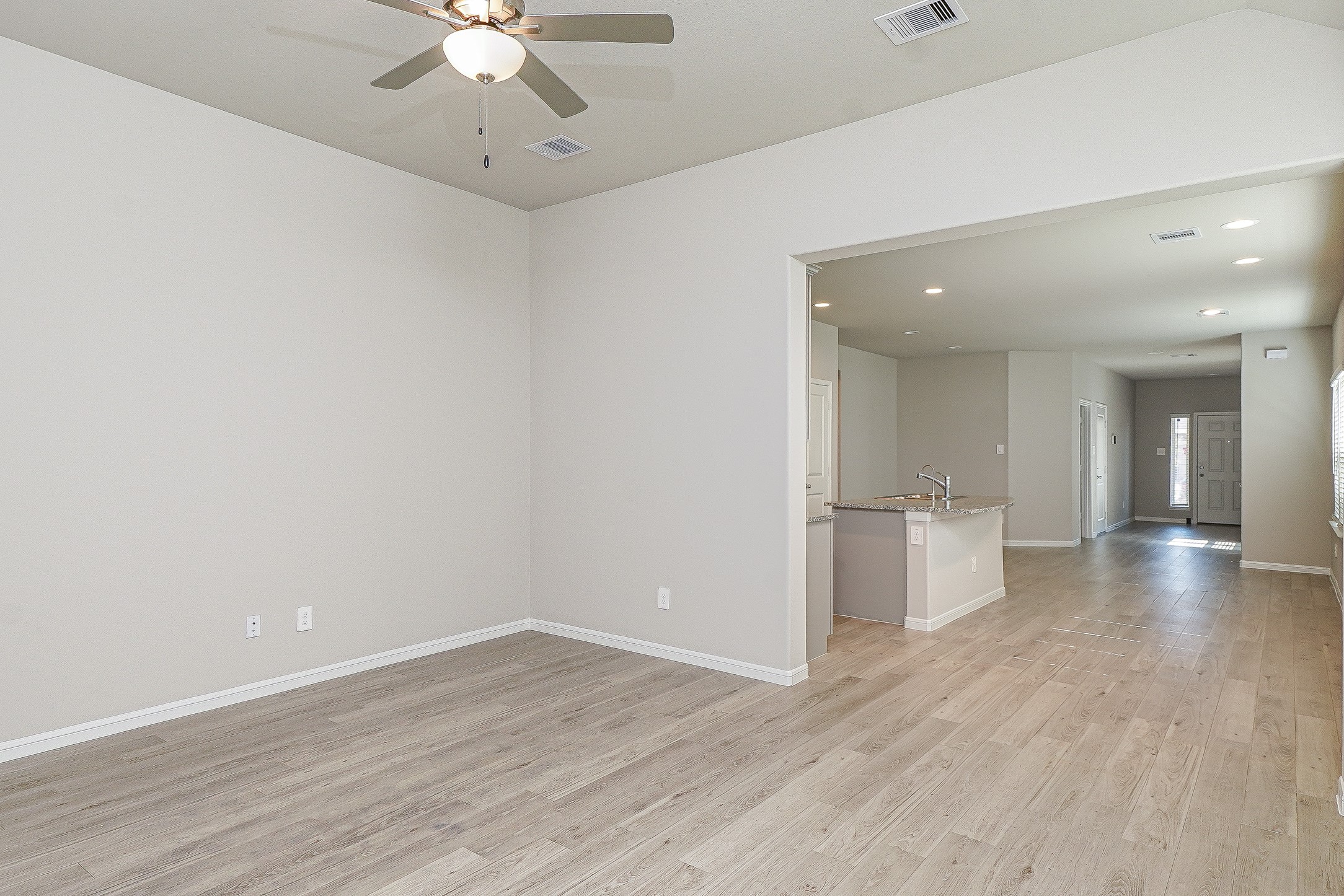 9254 Sea Gdn Street Houston, TX 77034 - Photo 11 of 33 wooden floor in an empty room with a window