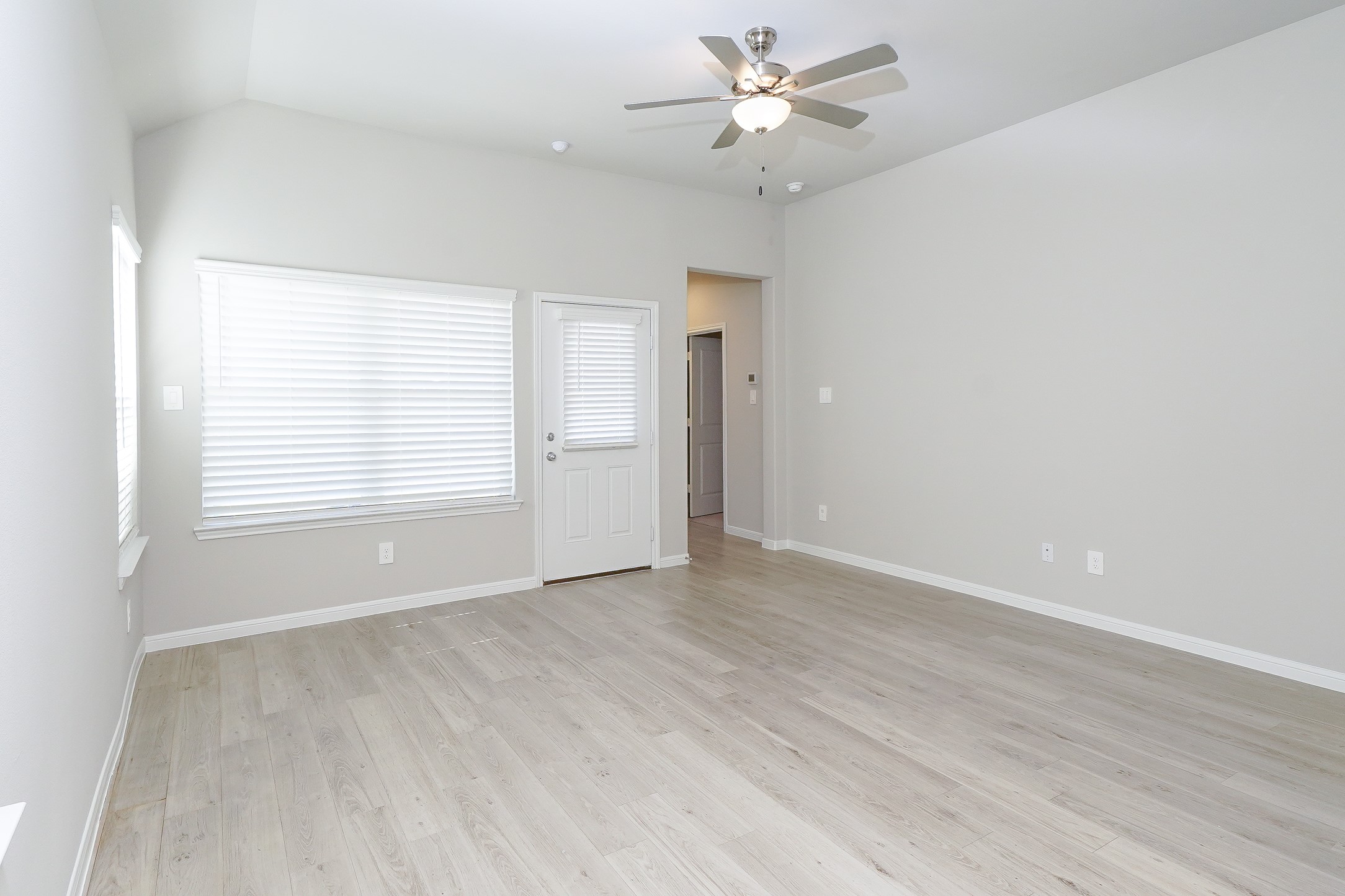 9254 Sea Gdn Street Houston, TX 77034 - Photo 12 of 33 wooden floor in an empty room with a window
