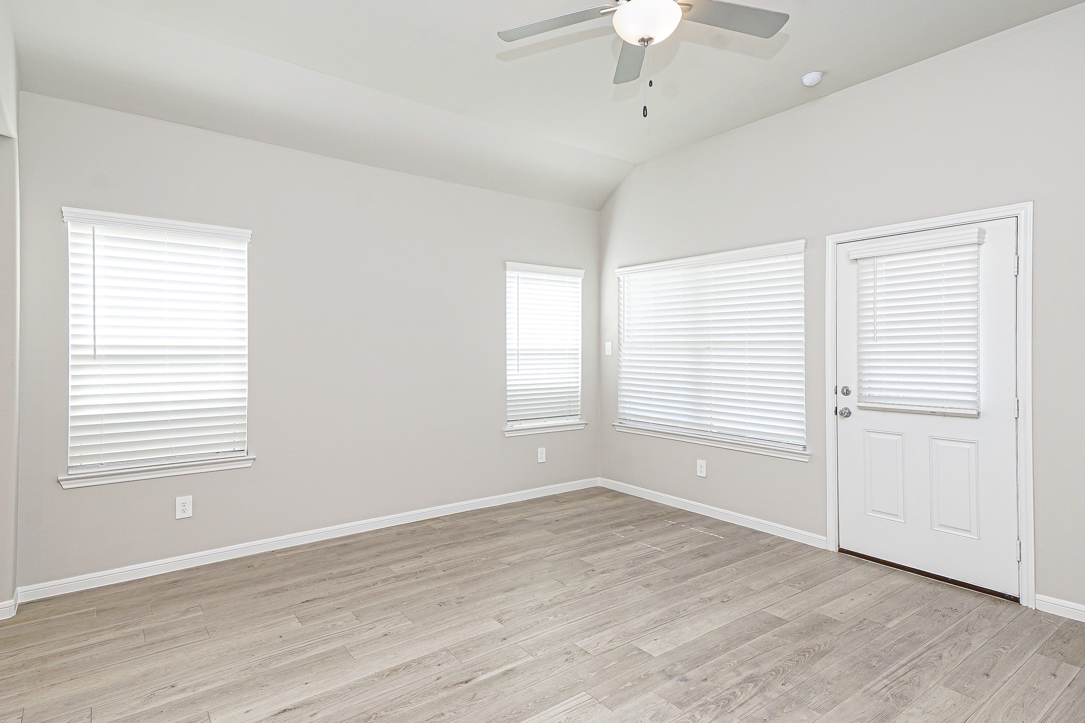 9254 Sea Gdn Street Houston, TX 77034 - Photo 16 of 33 an empty room with wooden floor chandelier fan and windows