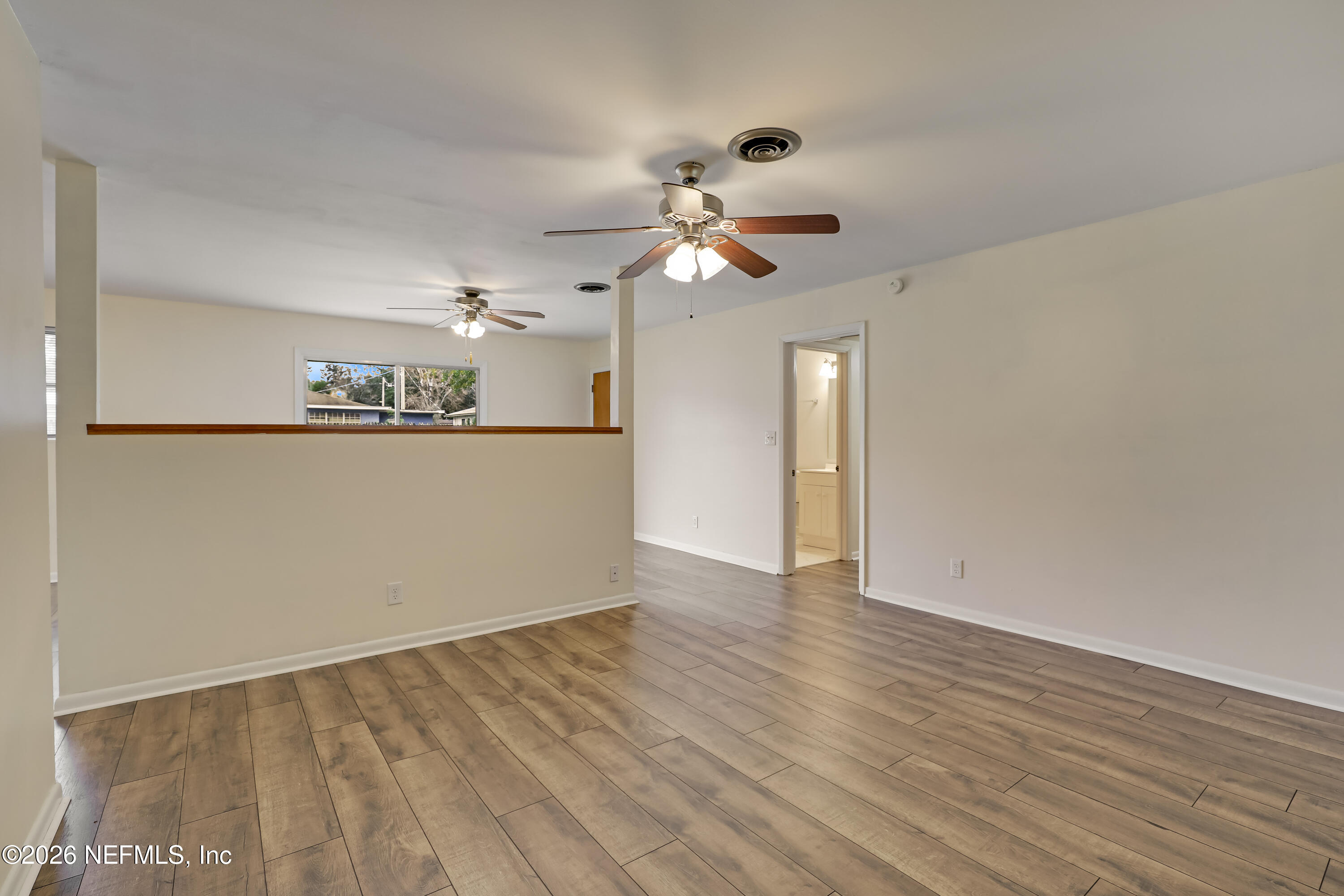 3944 Rodby Drive Jacksonville, FL 32210 - Photo 11 of 40 a view of a kitchen with wooden floor and a ceiling fan