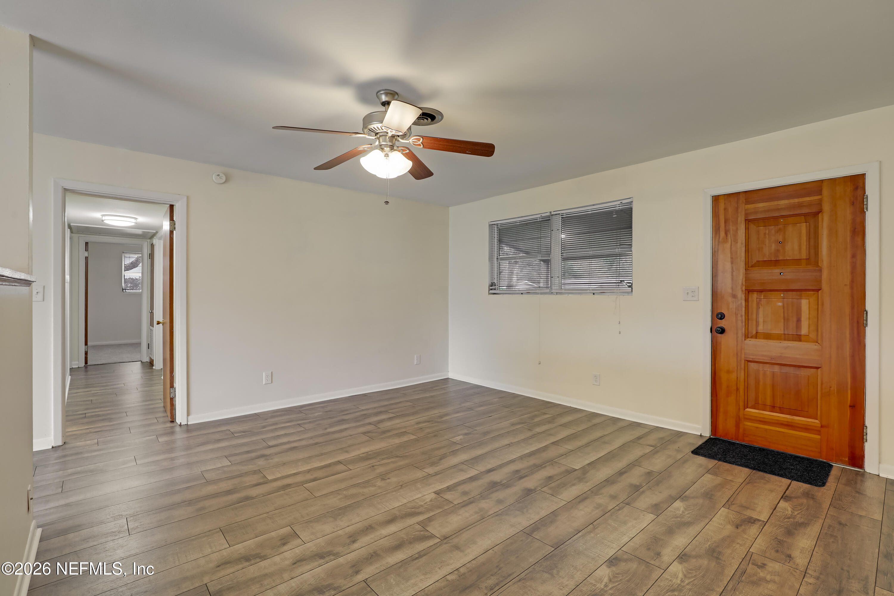 3944 Rodby Drive Jacksonville, FL 32210 - Photo 12 of 40 an empty room with wooden floor closet and ceiling fan
