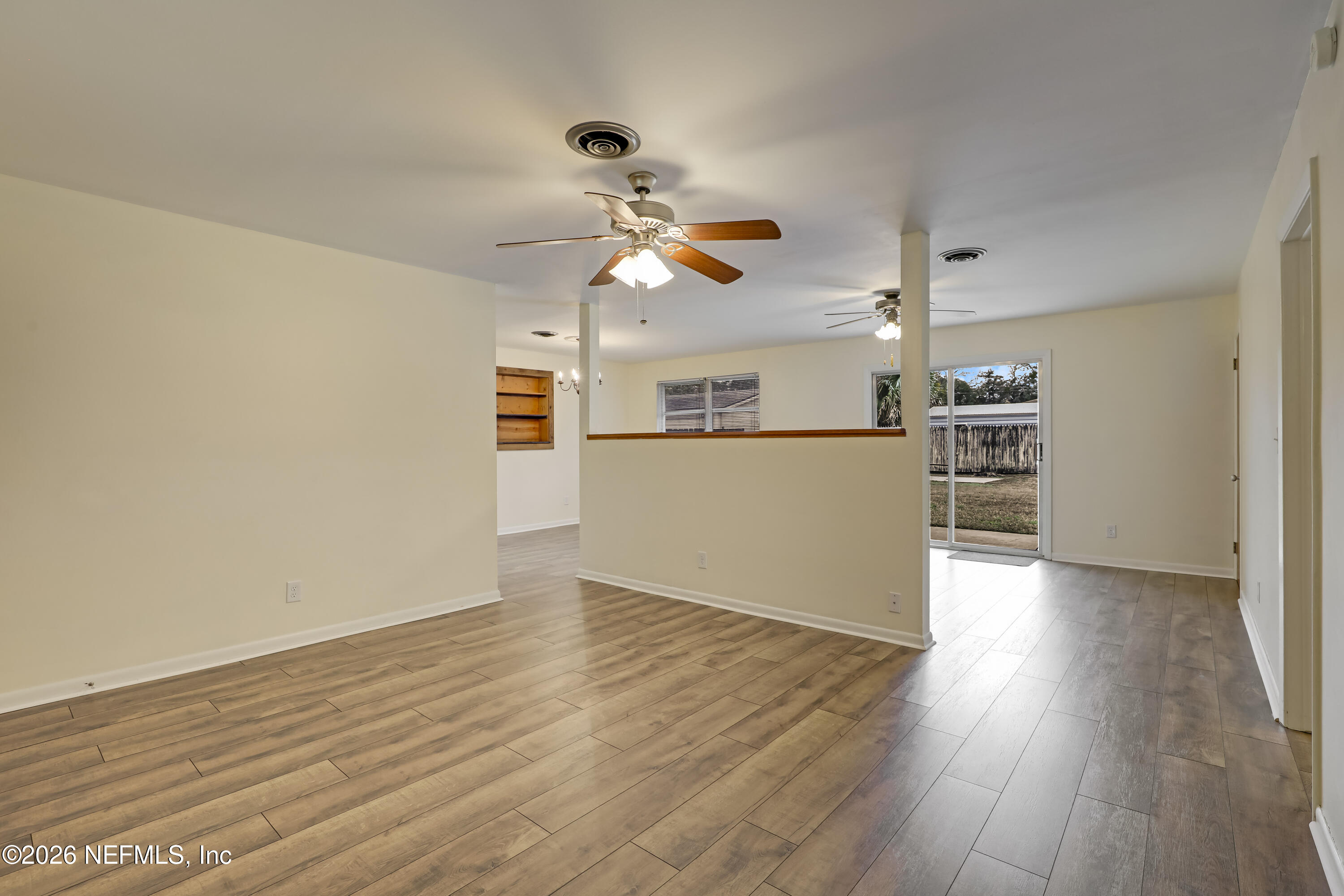 3944 Rodby Drive Jacksonville, FL 32210 - Photo 13 of 40 a view of a kitchen with wooden floor a ceiling fan and windows