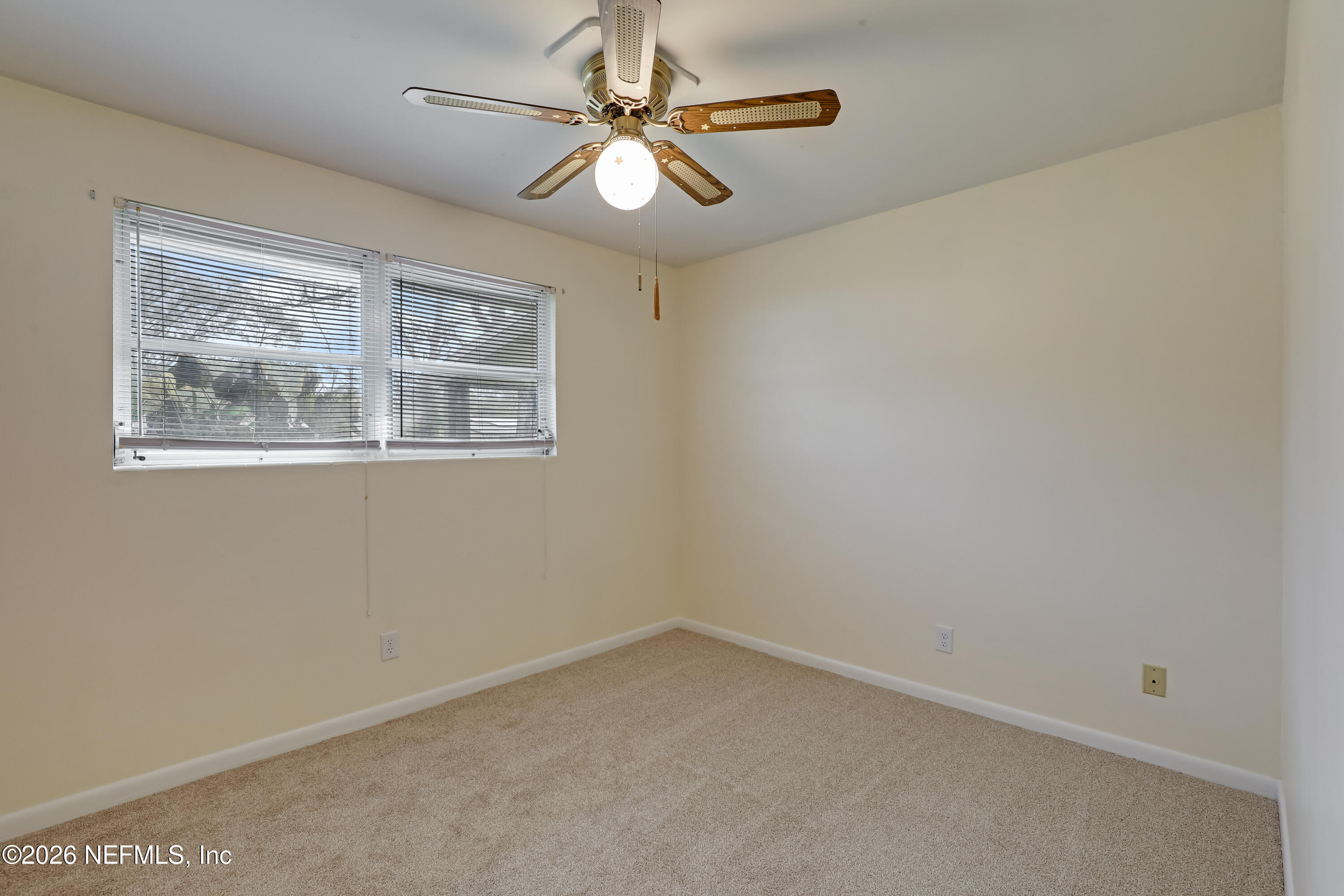 3944 Rodby Drive Jacksonville, FL 32210 - Photo 15 of 40 an empty room with a window and a fan