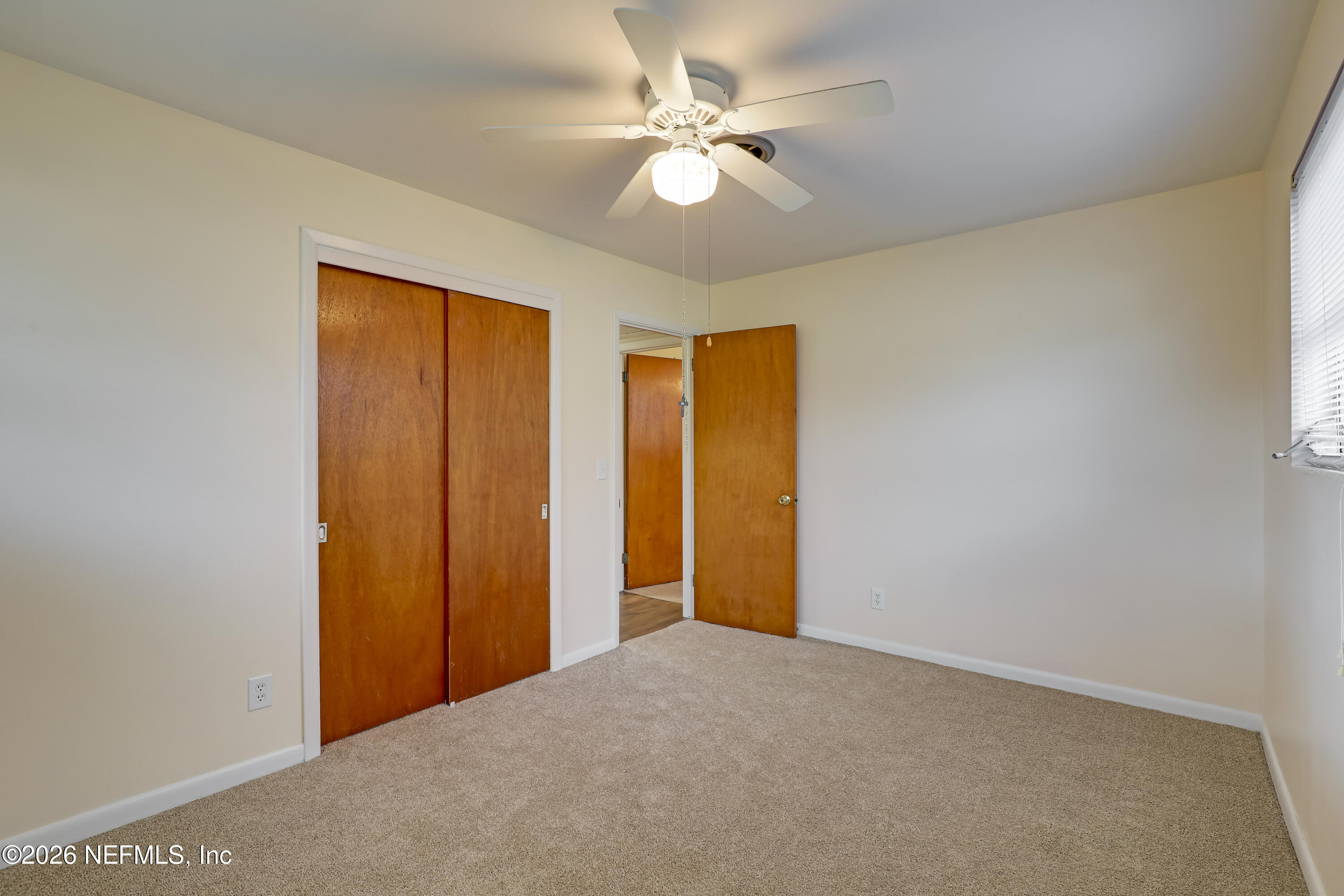 3944 Rodby Drive Jacksonville, FL 32210 - Photo 19 of 40 a view of a big room with closet and a ceiling fan