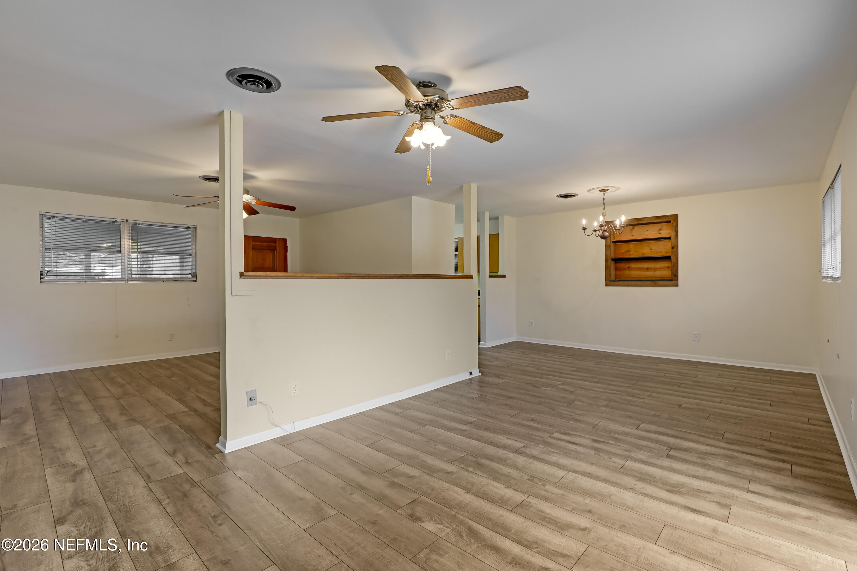 3944 Rodby Drive Jacksonville, FL 32210 - Photo 2 of 40 a view of a livingroom with a ceiling fan and wooden floor