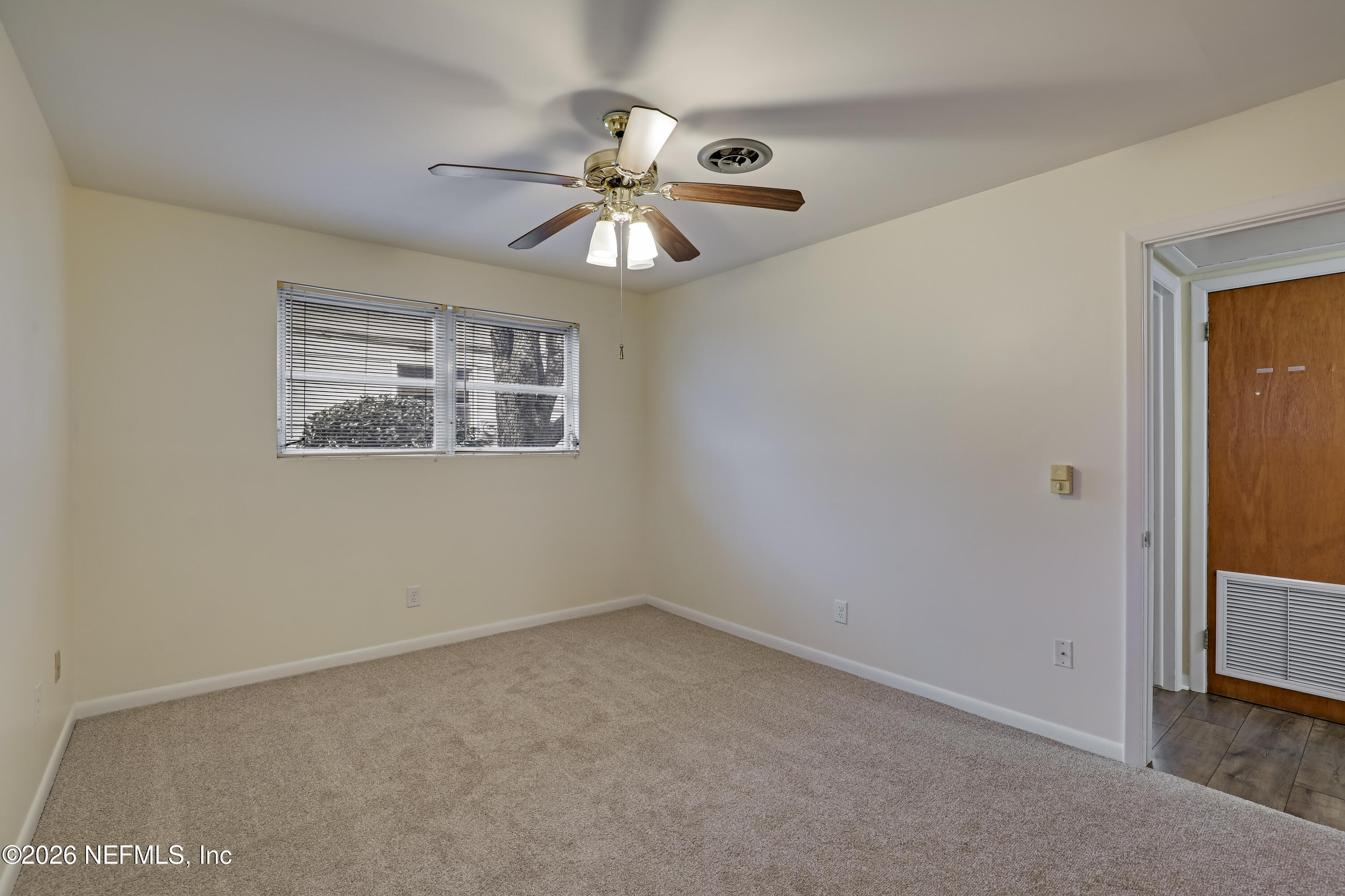 3944 Rodby Drive Jacksonville, FL 32210 - Photo 22 of 40 an empty room with a window and a fan