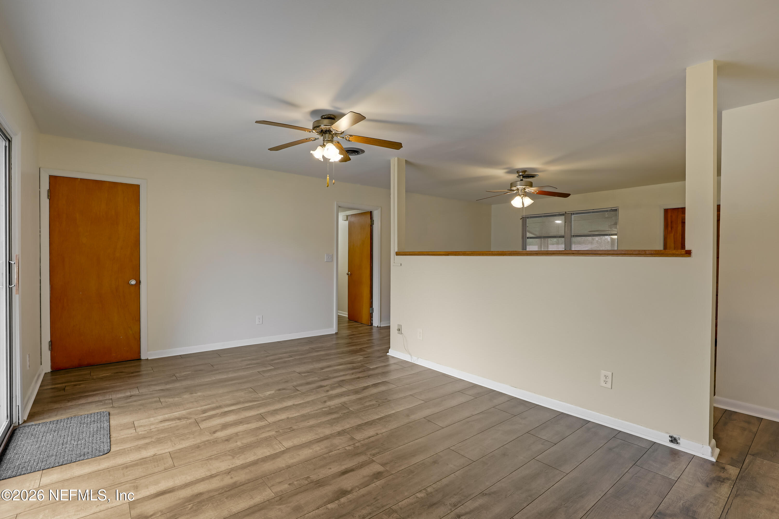 3944 Rodby Drive Jacksonville, FL 32210 - Photo 25 of 40 a view of a livingroom with a ceiling fan wooden floor and window