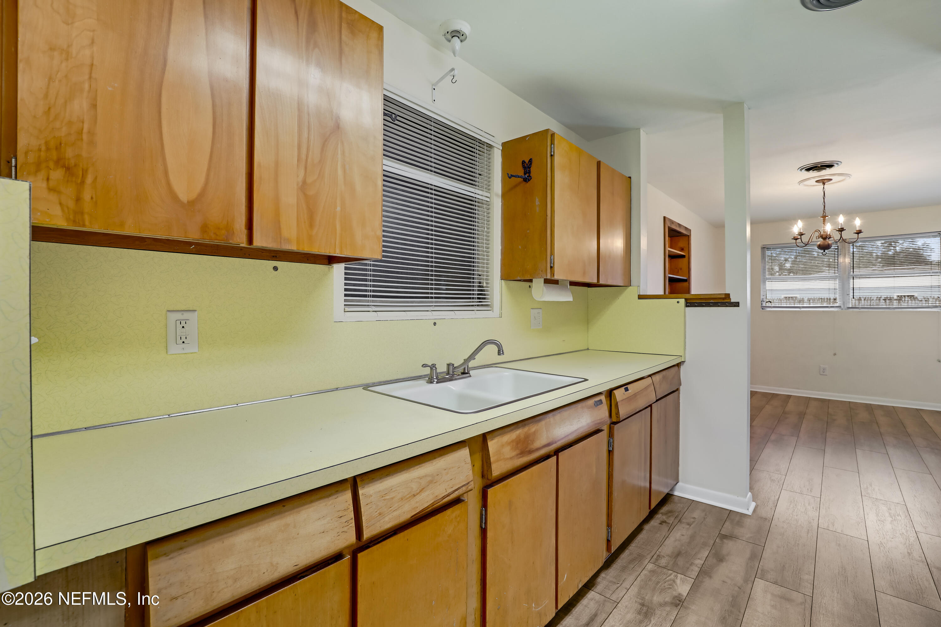 3944 Rodby Drive Jacksonville, FL 32210 - Photo 31 of 40 a kitchen with a sink and cabinets