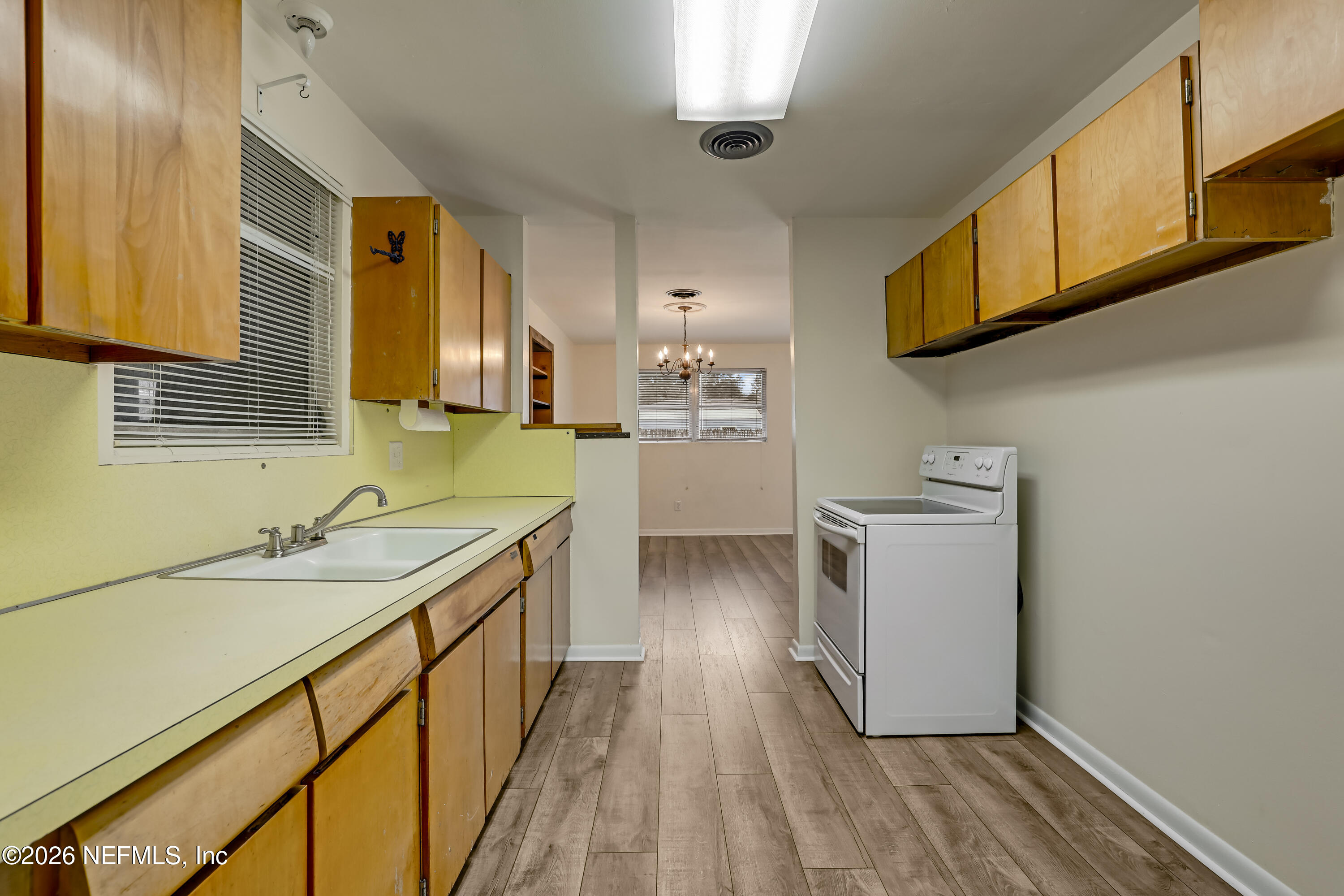 3944 Rodby Drive Jacksonville, FL 32210 - Photo 33 of 40 a kitchen with a sink stove and cabinets