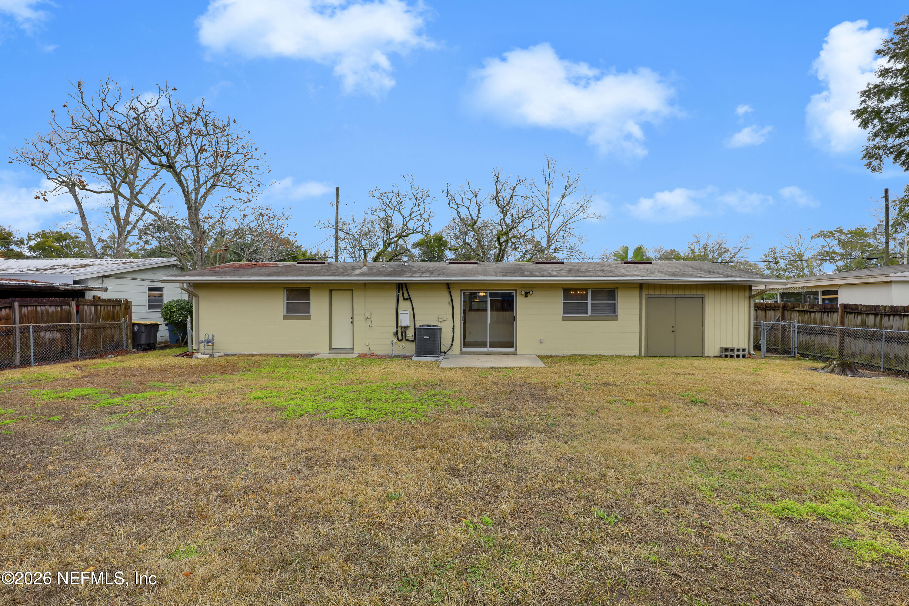 3944 Rodby Drive Jacksonville, FL 32210 - Photo 38 of 40 a view of a yard in front of a house with a large tree