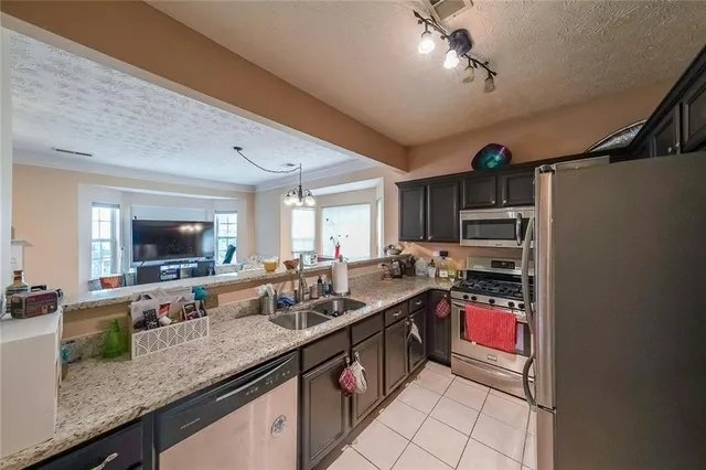 a kitchen with a sink stove and cabinets
