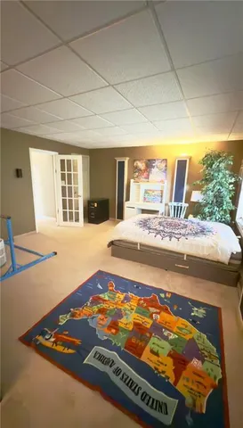 a living room with dining table and a large window