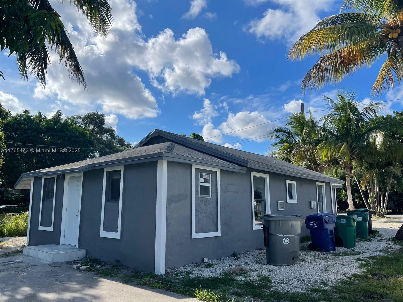 900 Northwest 80th Street Miami, FL 33150 - Photo 2 of 11 a front view of a house with balcony