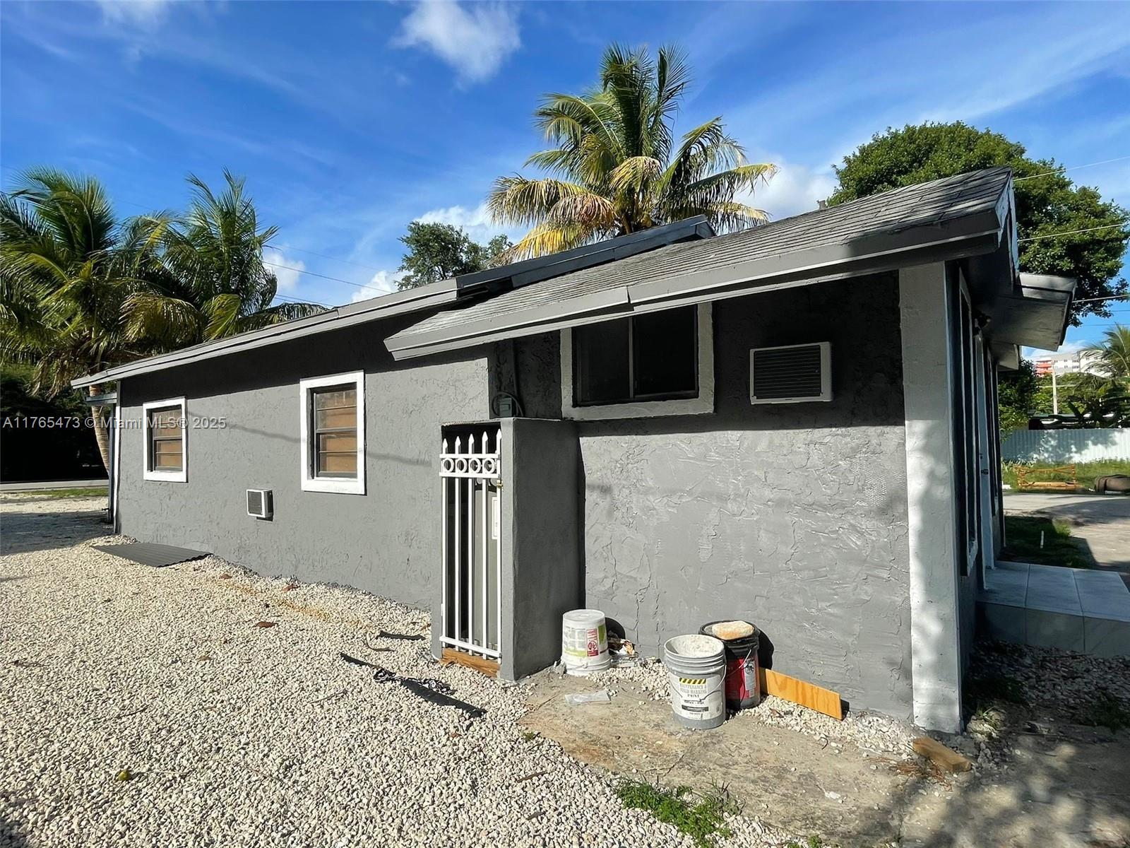 900 Northwest 80th Street Miami, FL 33150 - Photo 4 of 11 a front view of a house with a yard