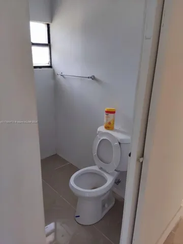 a white toilet sitting next to a small sink