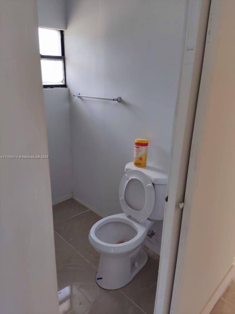 900 Northwest 80th Street Miami, FL 33150 - Photo 6 of 11 a white toilet sitting next to a small sink