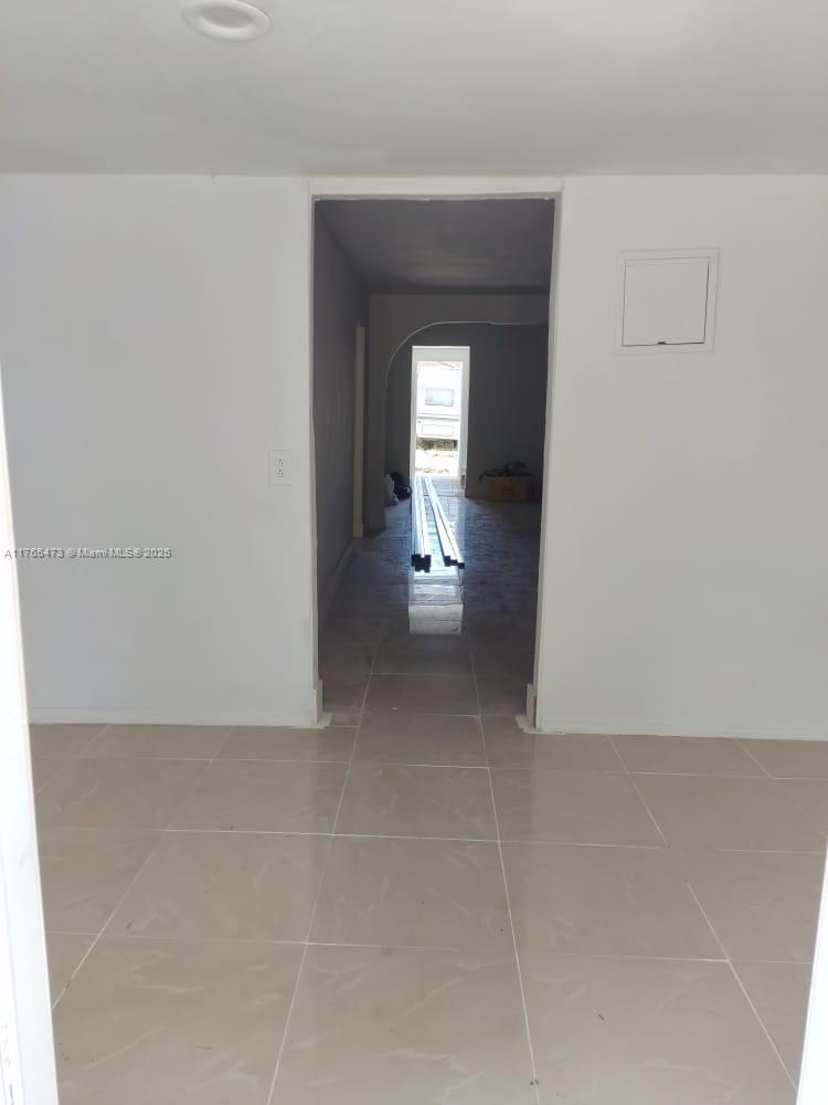 900 Northwest 80th Street Miami, FL 33150 - Photo 10 of 11 a view of a hallway with wooden floor