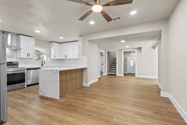 a view of a kitchen with a sink and a stove top oven