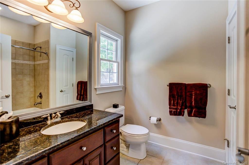 5908 Johnson Road Clover, SC 29710 - Photo 13 of 23 a bathroom with a granite countertop sink toilet a mirror and shower