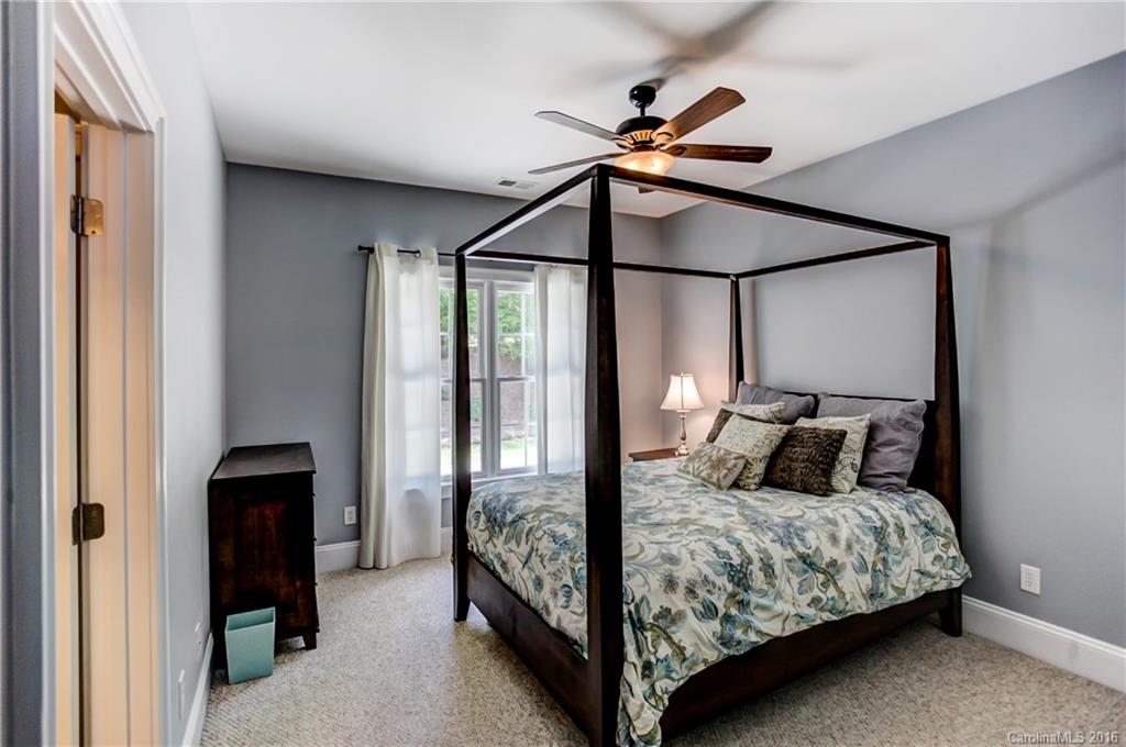 5908 Johnson Road Clover, SC 29710 - Photo 14 of 23 a bedroom with a bed and a chandelier