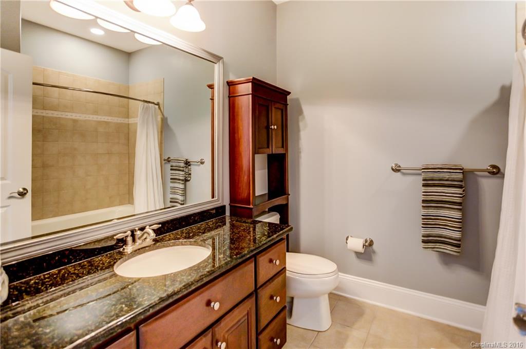 5908 Johnson Road Clover, SC 29710 - Photo 15 of 23 a bathroom with a granite countertop toilet sink and mirror