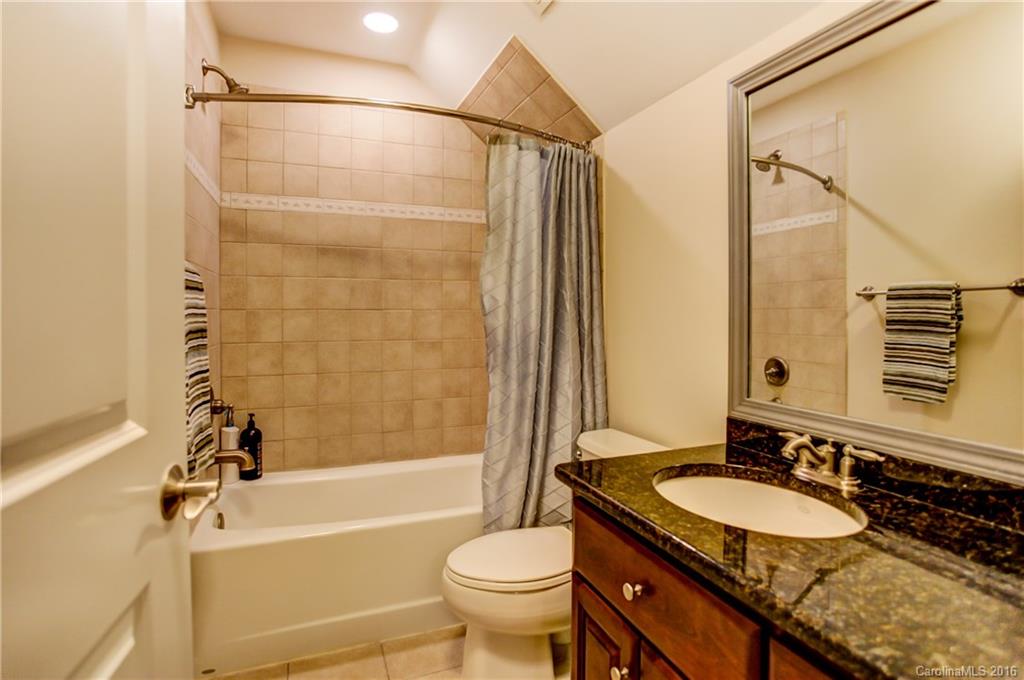 5908 Johnson Road Clover, SC 29710 - Photo 18 of 23 a bathroom with a granite countertop sink toilet mirror and shower