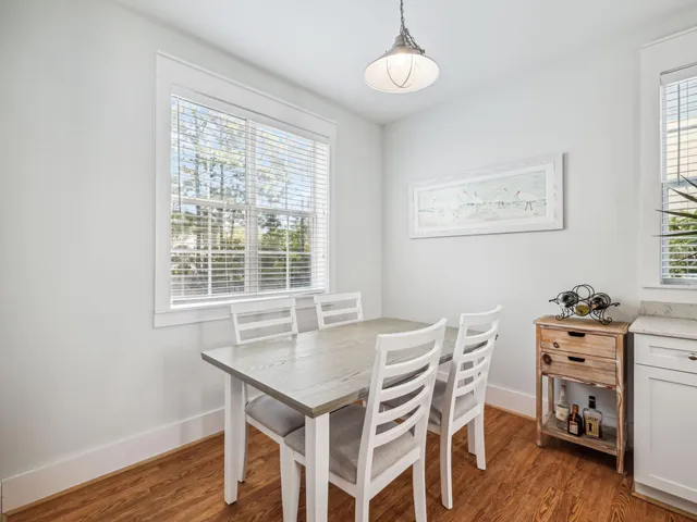 a living room with furniture and a view of kitchen
