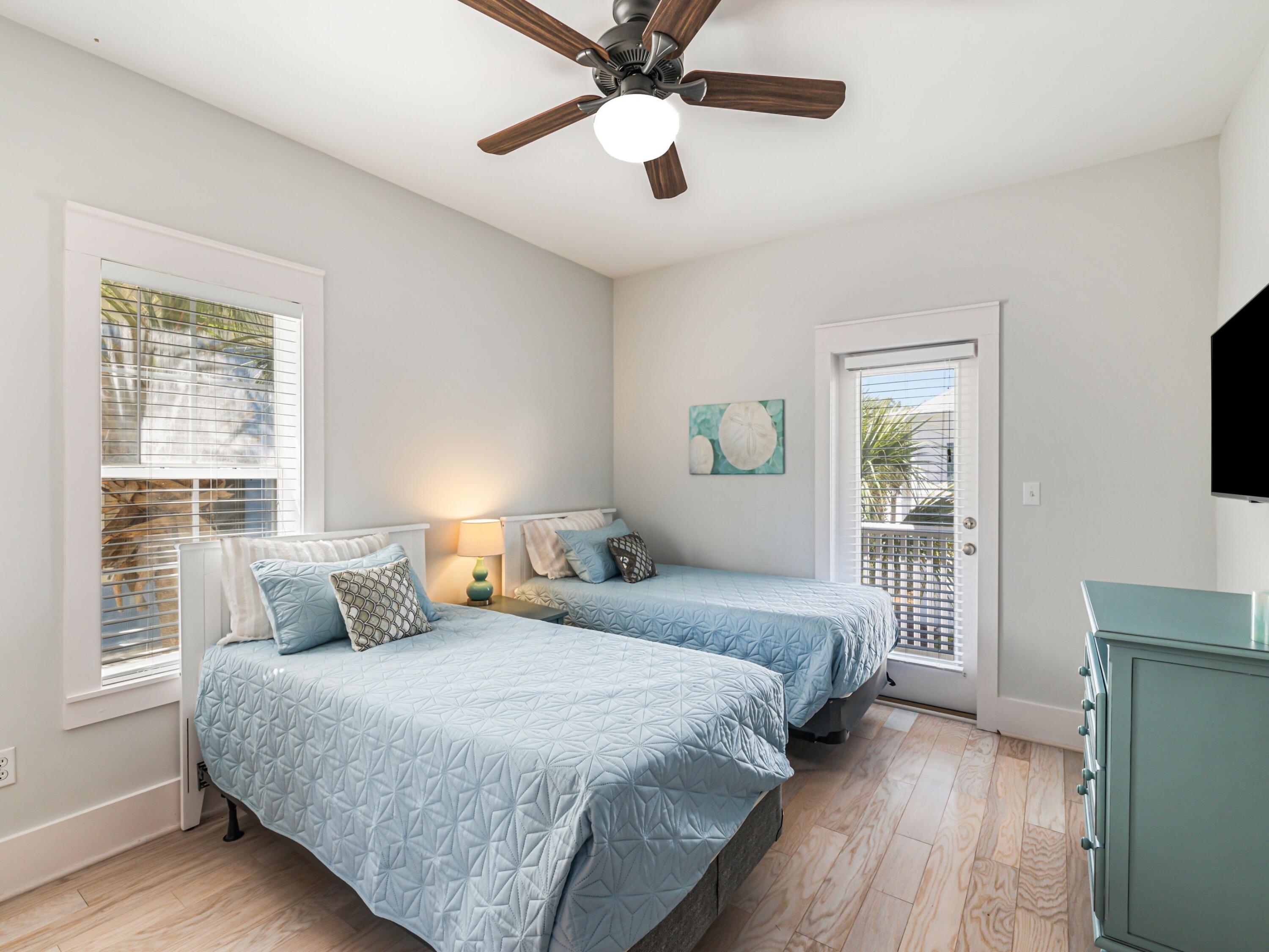 198 Somerset Bridge Road, Unit 103 Santa Rosa Beach, FL 32459 - Photo 25 of 39 a bedroom with a bed and a chandelier
